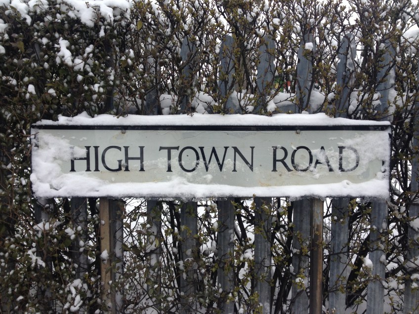 High Town Road sign, covered by snow.